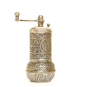 Traditional copper pepper mill on white