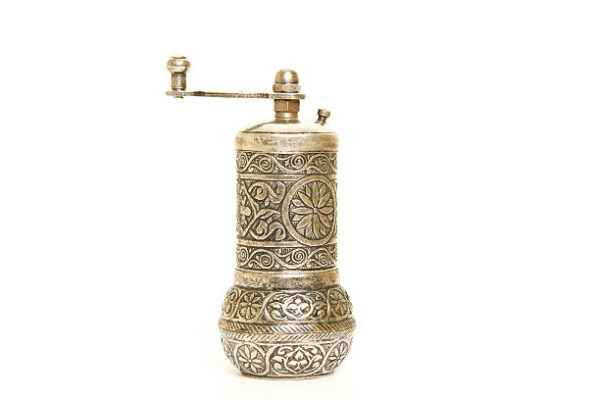 Traditional copper pepper mill on white